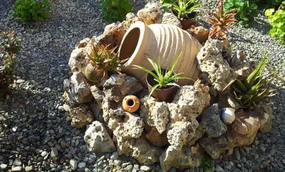 a rock garden with a toilet and plants in it at Nicolas Studios & Apartments in Agia Marina Nea Kydonias