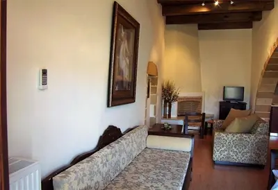a living room with a couch and a television at Maria Villas in Kissamos