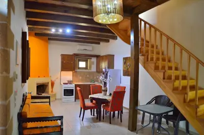 a kitchen and dining room with a table and chairs at Maria Villas in Kissamos
