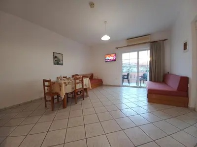 a living room with a table and a couch at Babis Apartments in Plataniás