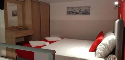 a small bedroom with a bed and a mirror at Rodoula Luxury Apartment 1 in Chania Town