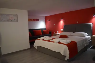 a bedroom with a large bed and a couch at Rodoula Luxury Αpartment 2 in Chania Town