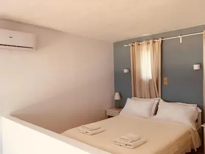 a small bedroom with a bed with towels on it at Theodosia Studios in Kalathas