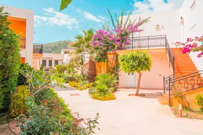 a courtyard of a building with flowers and trees at Oreia in Palaiochóra