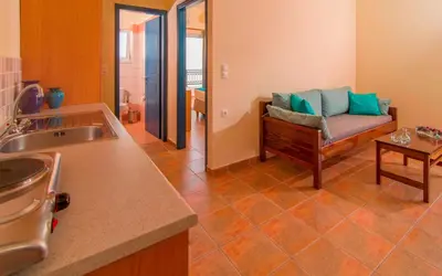a kitchen with a couch and a living room at Oreia in Palaiochóra