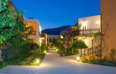 a pathway between two buildings at night with lights at Oreia in Palaiochóra