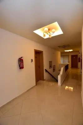 an empty room with a ceiling fan and a staircase at Hotel Aghas Paleochora in Palaiochóra