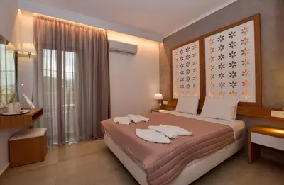 a bedroom with a bed with two towels on it at Hotel Aghas Paleochora in Palaiochóra