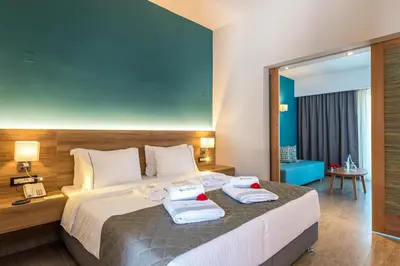 a hotel room with a bed with towels on it at Solimar Aquamarine Resort in Gerani Chanion
