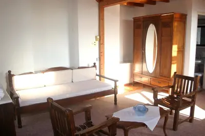 a living room with a couch and a table and chairs at Oasis Guesthouse in Chania Town