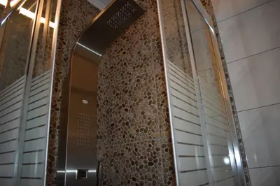 a hallway in a building with a stone wall at Rodoula Luxury Αpartment 4 in Chania Town