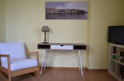 a desk in a room with a chair and a television at Central House with Quiet Garden in Kissamos