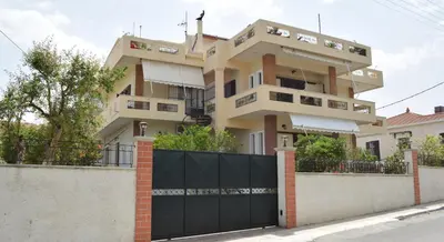 a house with a black gate in front of it at Central House with Quiet Garden in Kissamos