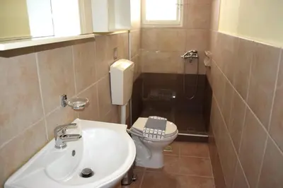 a small bathroom with a sink and a toilet at Central House with Quiet Garden in Kissamos