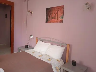 a bedroom with a bed and a picture on the wall at Sitzanaki Home in Chania Town