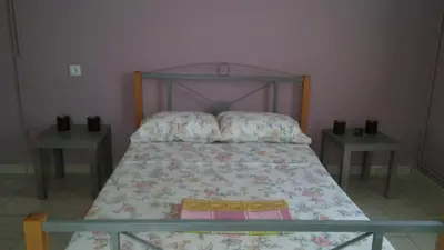 a bedroom with a bed with two night stands at Sitzanaki Home in Chania Town