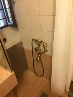 a shower with a faucet in a bathroom at Rooms 47 in Chania Town