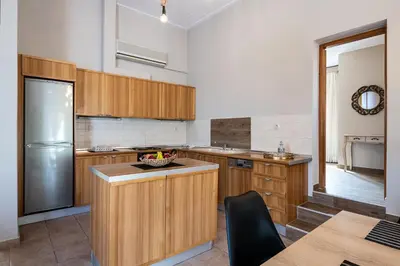 a kitchen with wooden cabinets and a counter top at Lila hill house in Stalos