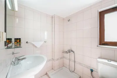 a bathroom with a tub and a toilet and a sink at Lila hill house in Stalos