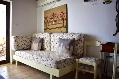 a living room with a couch with flowers on it at Marinakis Sea View Studios in Sougia