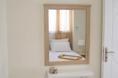 a mirror on a wall with a bed in a room at Aelia Apartments in Chania Town