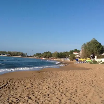 a beach with a lot of footprints in the sand at Astra Hotel Apartments in Kato Daratso