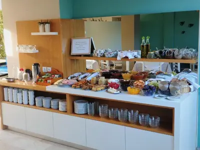 a buffet line with plates and food on display at Hotel Peli in Kissamos
