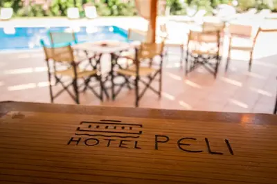 a sign that reads hotel real with chairs and tables at Hotel Peli in Kissamos