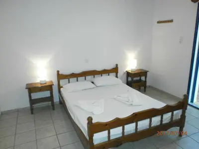 a bedroom with a bed and two night tables at Fragokastello Star in Frangokastello
