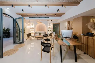a living room with a glass table and chairs at Evexia Boutique Hotel & Spa in Agia Marina Nea Kydonias