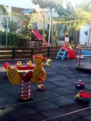 a playground with a toy chicken and toy cars at Melina Beach in Plataniás