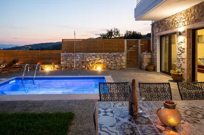 a backyard with a swimming pool and a house at Istros Villas - with Pools, BBQ & Heated Spa Whirlpools, By ThinkVilla in Korakiaí