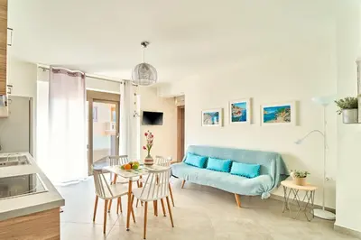 a living room with a blue couch and a table at Lydia's Apartments in Kissamos