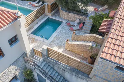an overhead view of a swimming pool with stairs and a house at Olive Villas in Kría Vrísi