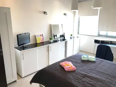a bedroom with a bed with two pillows on it at Heart City Executive Suite in Chania Town