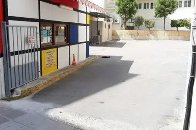 an empty parking lot in front of a building at Heart City Executive Suite in Chania Town
