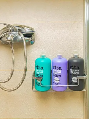 three bottles of water are on a shelf in a bathroom at Antonia Traditional Estate in Chania Town