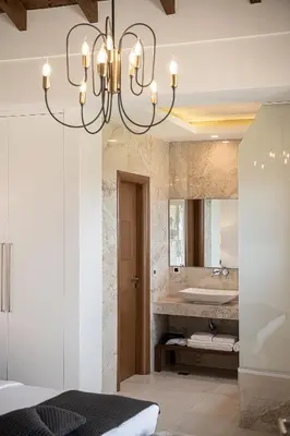 a bathroom with a chandelier and a sink at Villa Aloni in Kissamos