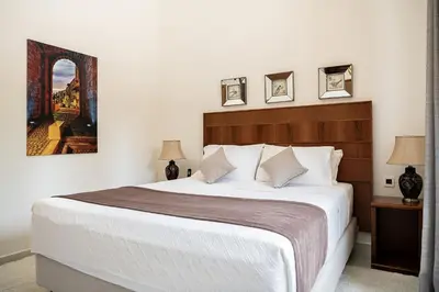 a bedroom with a large bed with white sheets at Villa Aloni in Kissamos