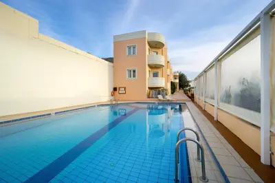 a swimming pool on the side of a building at Georgina in Agia Marina Nea Kydonias