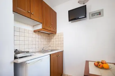 a kitchen with a sink and fruit on a counter at Georgina in Agia Marina Nea Kydonias