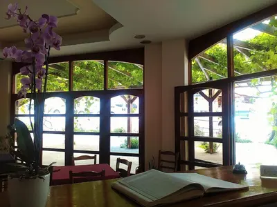 a table with an open book on a table with windows at Lefka in Kolymvari