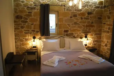 a bedroom with a bed with flowers on it at Villa Antonousa - Private Pool Oasis in Kerá