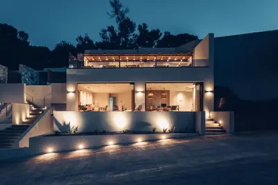 a house lit up at night with lights at Monastery Estate Retreat in Sougia