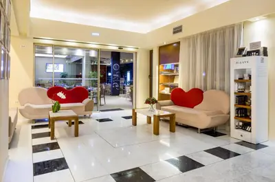 a lobby with two red hearts on the couches at Oscar Suites & Village in Agia Marina Nea Kydonias