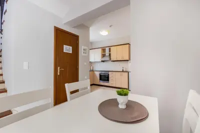 a small kitchen with a table with a vase on it at Orion Star in Agia Marina Nea Kydonias
