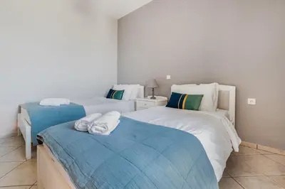 a bedroom with two beds with towels on them at Orion Star in Agia Marina Nea Kydonias