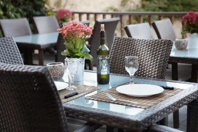 a table with a bottle of wine and glasses at Sun Nicolas in Kato Daratso