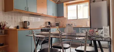 a kitchen with a table and chairs in a kitchen at Modern Apartment Chania Center in Chania Town