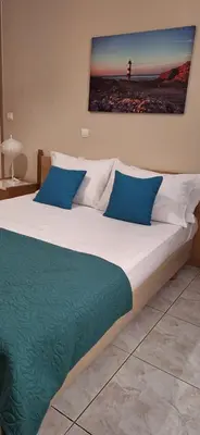 a bedroom with a large bed with blue pillows at Modern Apartment Chania Center in Chania Town